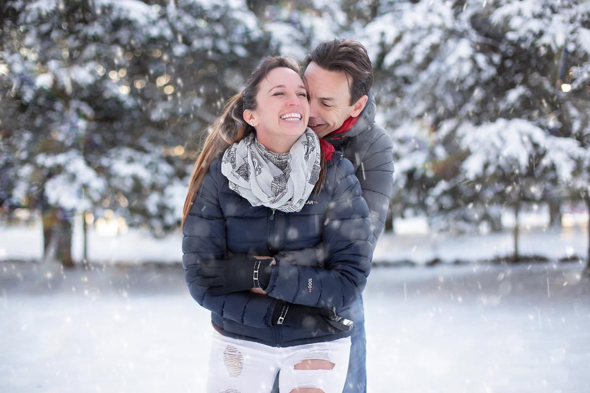 couple in the snow laughing and in love