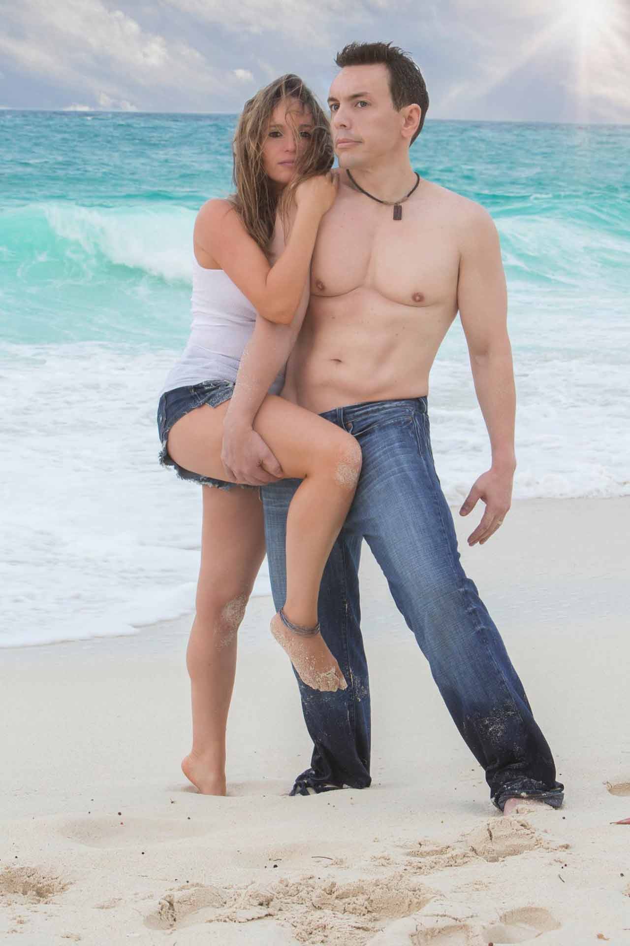 couple standing on the beach seductively